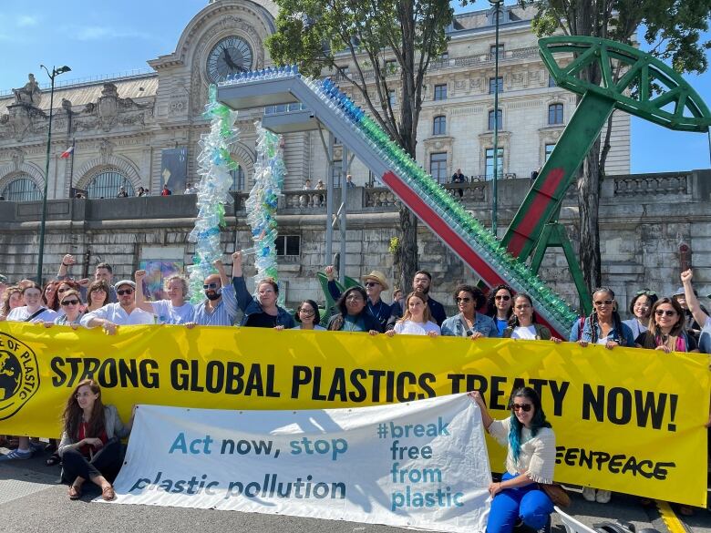 Activists call for a global plastics treaty in Paris in May 2023. 