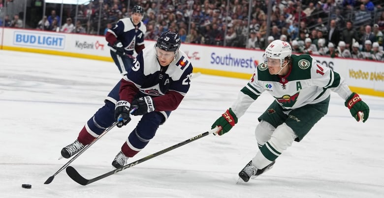 A right-handed shooter goes wide to his right past a defender holding his stick outstretched with his right hand.