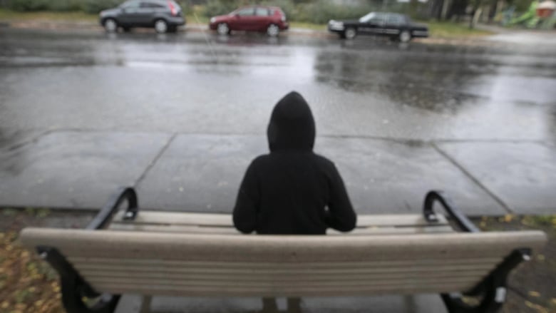 A person sits on a bench.