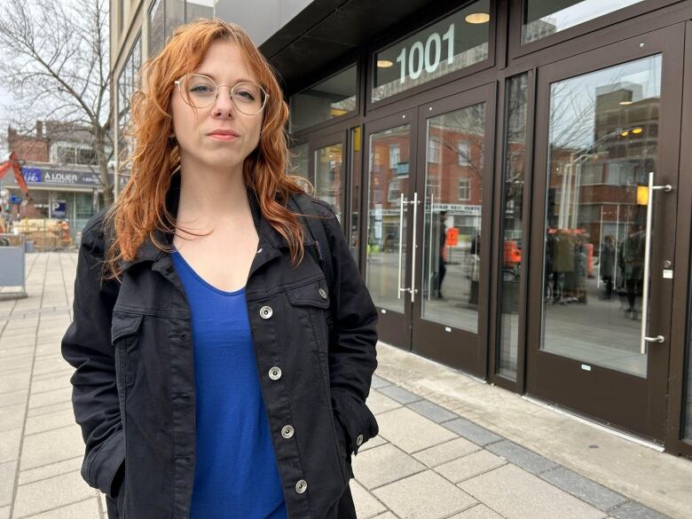 A woman stands in the street.