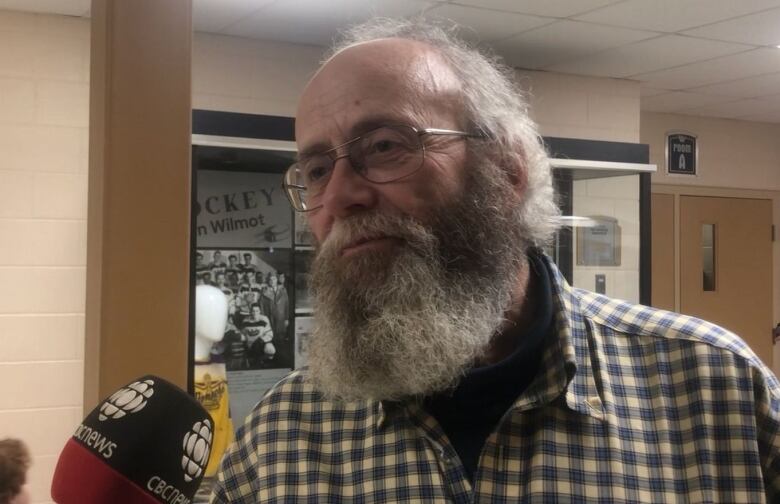 A man getting interviewed with a microphpone. 