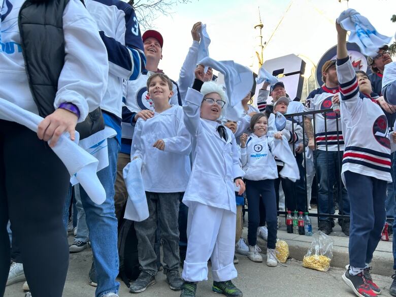 A kid dressed in a Colonel Saunders costume.