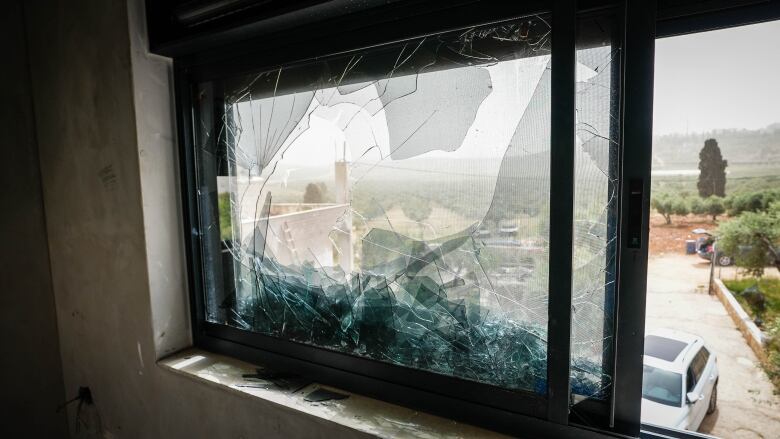 A shattered window in a home of Abdullatif Abu Alia.