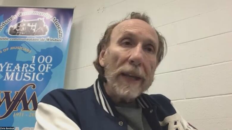 A senior-age man being interviewed via Zoom