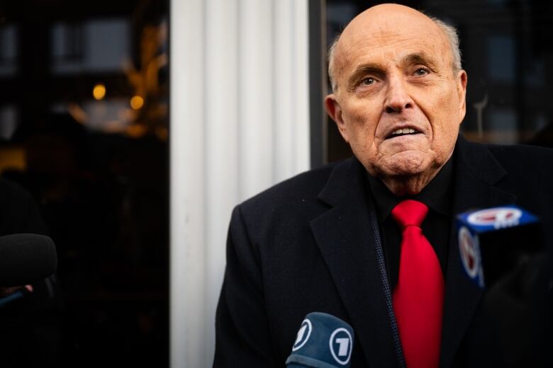 Rudy Giuliani is seen speaking to members of the media in Manchester, N.H., in January 2024.