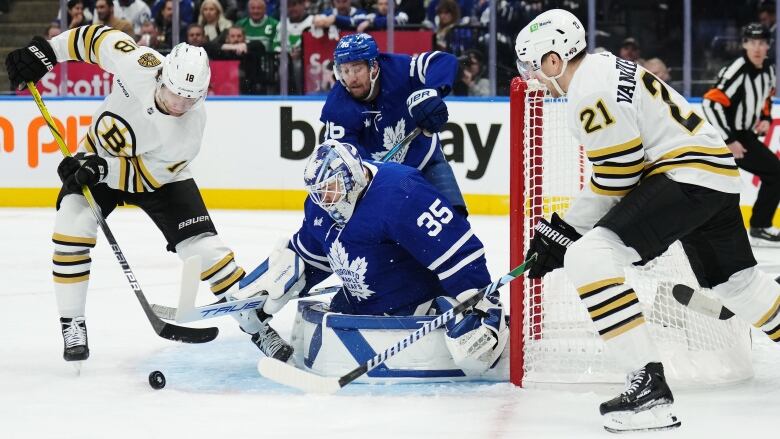 Toronto Maple Leafs goaltender Ilya Samsonov (35) makes a save on Boston Bruins' Pavel Zacha (18) as Maple Leafs' Ilya Lyubushkin (46) defends and Bruins' James van Riemsdyk (21) looks for a rebound during first period action in Game 3 of an NHL hockey Stanley Cup first-round playoff series in Toronto on Wednesday, April 24, 2024. THE CANADIAN PRESS/Nathan Denette