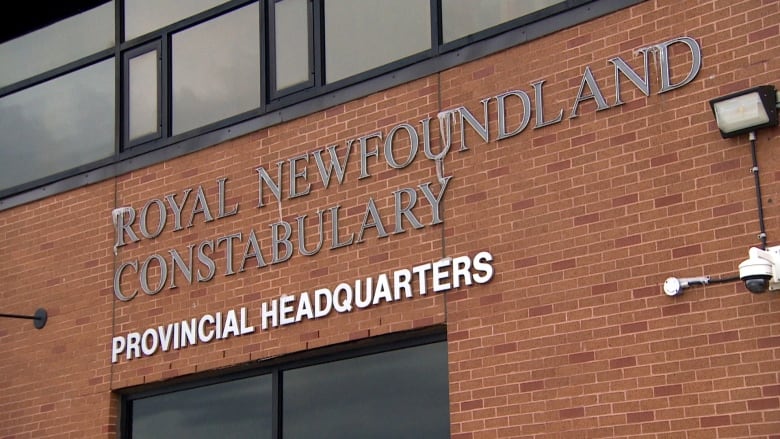 A red brick building with silver lettering. 