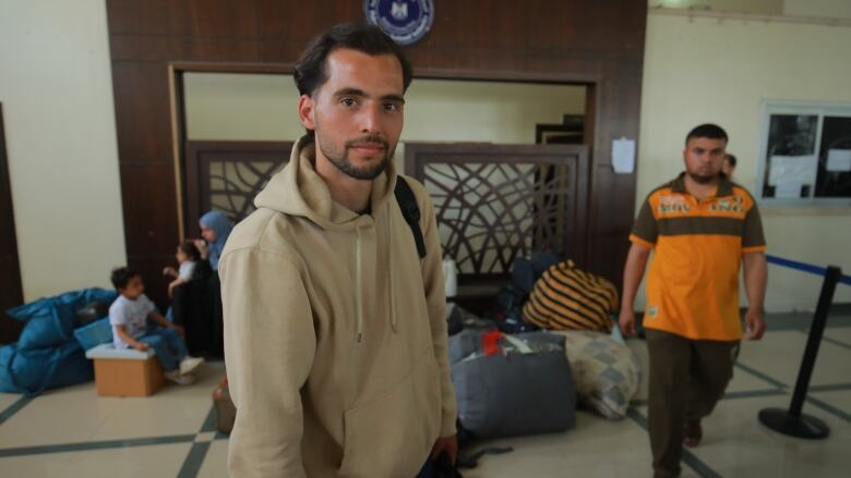 A man waits at a border crossing terminal.