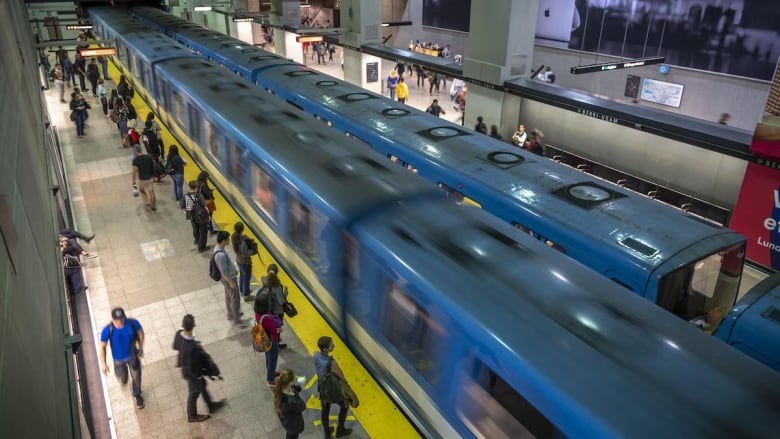 People waiting at the Berri-UQAM Metro Station.