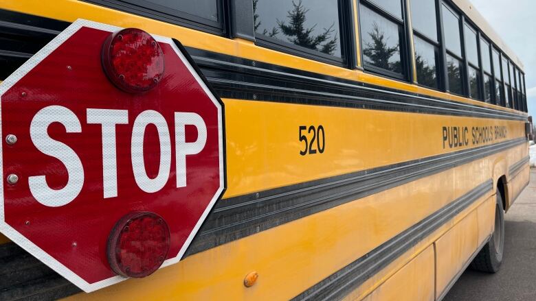 A school bus with a stop sign on the side.