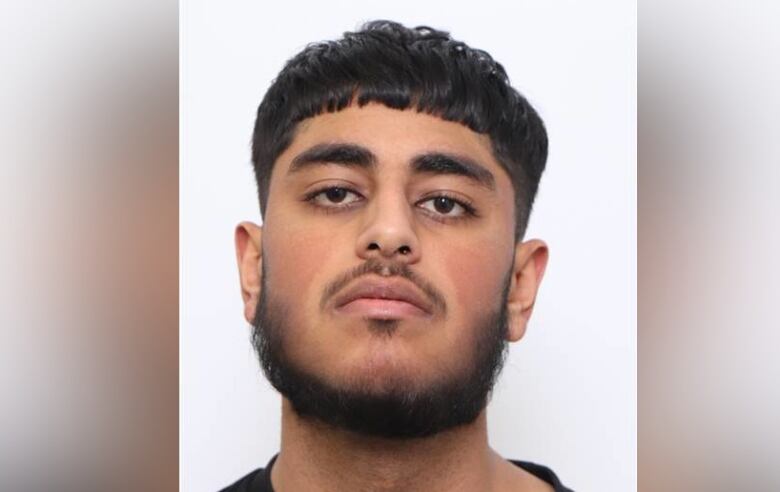 A man is pictured looking at the camera for a head shot photo.