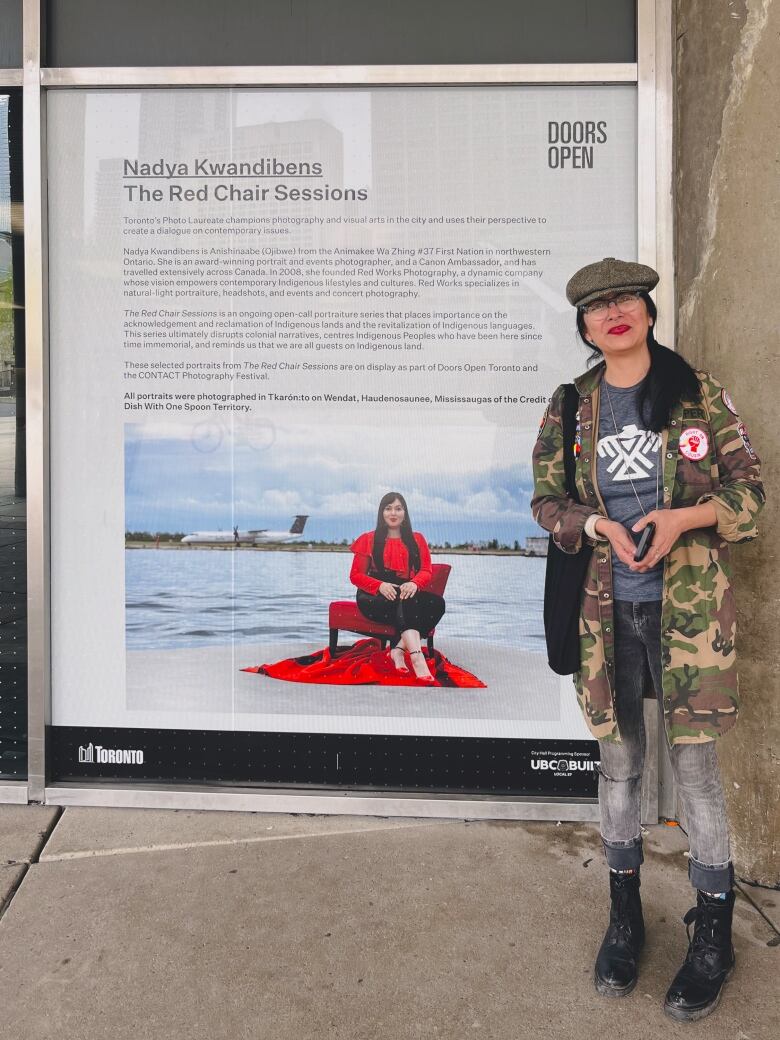 Woman in front of sign.