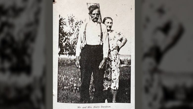 A black-and-white image of a man and a woman from about a century ago.