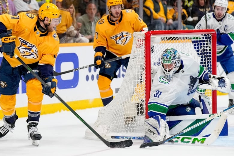 A goalie blocks a shot.