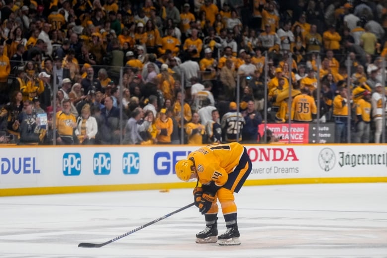 A hockey player bent over in despair.