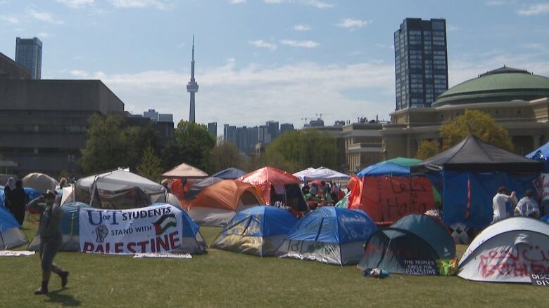 The CN Tower is pictured behind tents set up at the University of Toronto. 