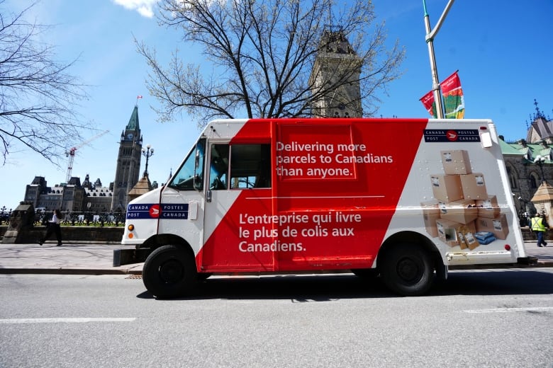 A Canada Post parcel delivery vehicle parks on Wellington Street and Parliament Hill in Ottawa, Thursday, May 5, 2022.