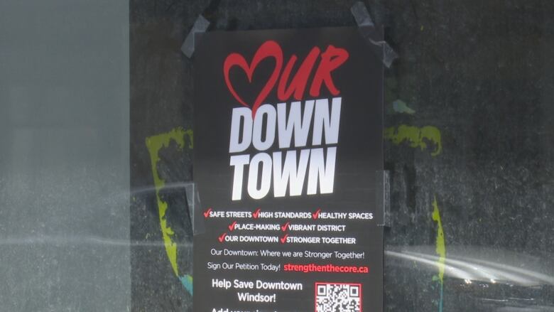 A poster on the window of a closed business.