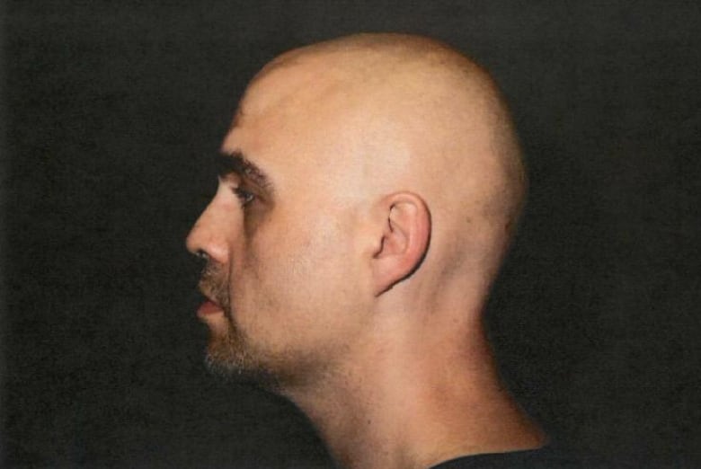 A side profile of a bald man.