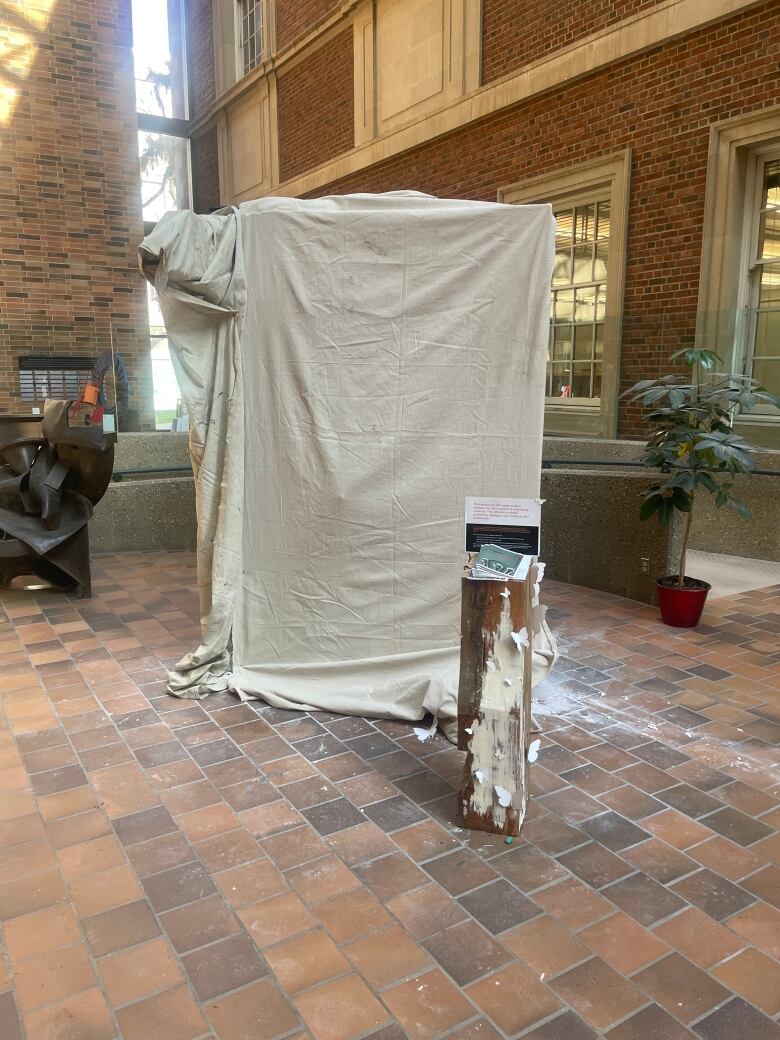 A blanket is covering an art installation.