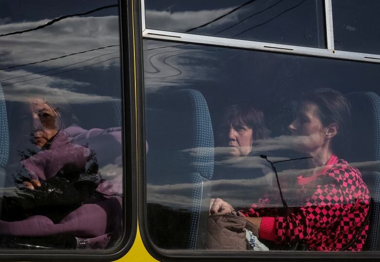 Local residents from Vovchansk and nearby villages sit on a bus during an evacuation to Kharkiv due to Russian shelling, amid Russia's attack on Ukraine, at an undisclosed location near the town of Vovchansk in Kharkiv region, Ukraine May 10, 2024.