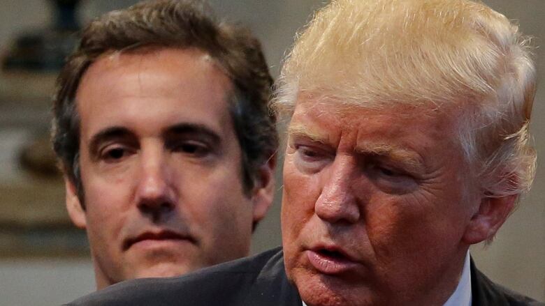 Michael Cohen, left, stands next to Donald Trump in this photo from September 2016. Cohen is expected to testify at Trump's criminal trial on Monday.