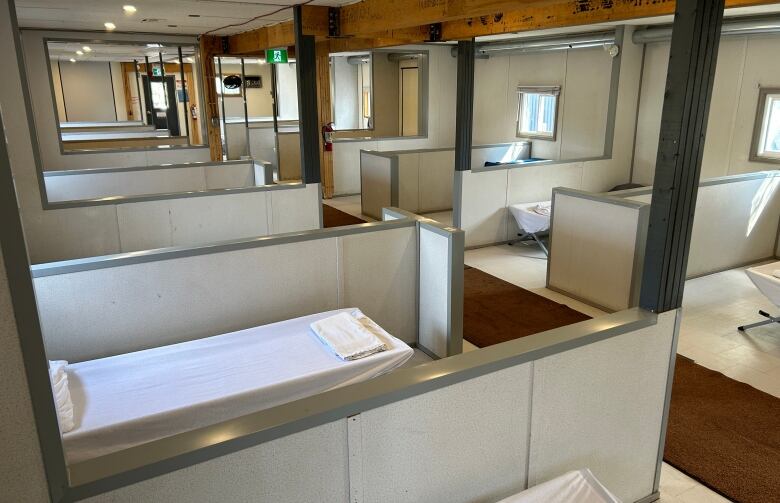 A large room with rows of cubicle-type bedrooms 