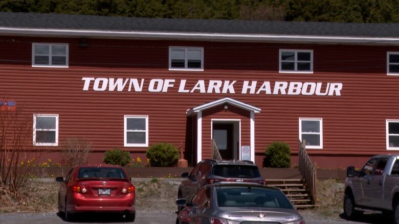 A picture of a building that reads Town of Larkharbour in big letters. 