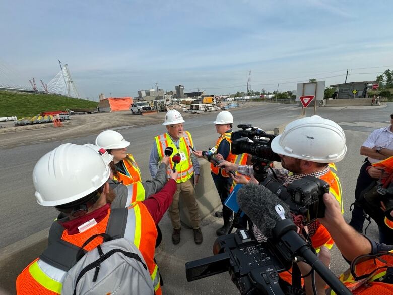 A man surrounded by reporters