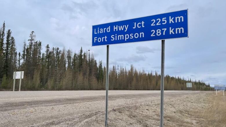 A road sign along a two-lane highway.