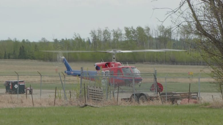 A helicopter in a field.