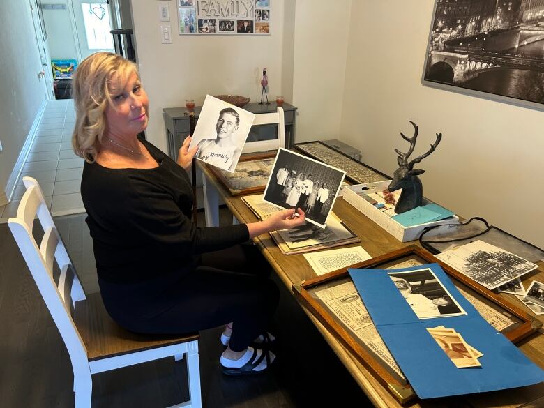 Vicki Wagner, with a picture of her grandfather, Len O'Hara. He was one of four people to survive the 1926 Balsam Lake tragedy.