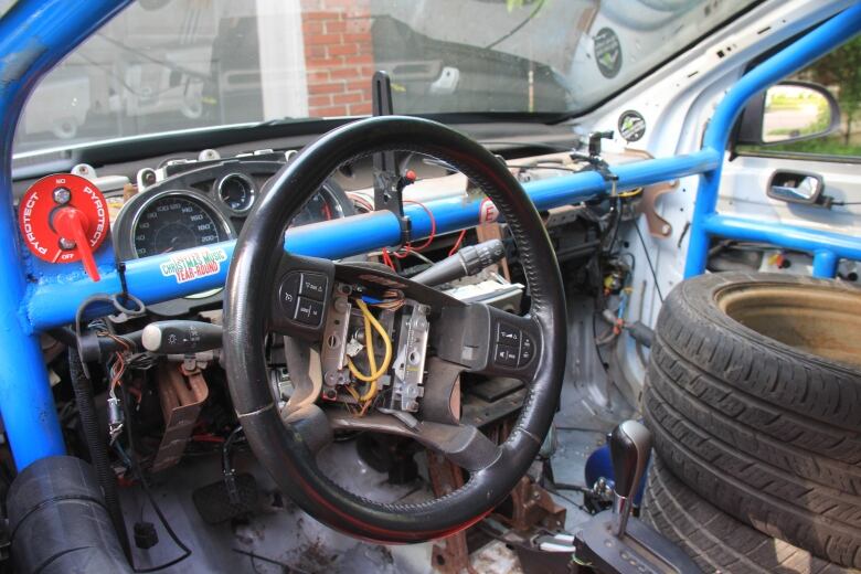 The stripped inside of a car with wiring and metal exposed