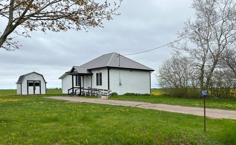 White building with shed.