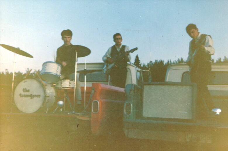 A band plays in the back of pickup trucks