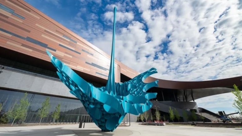 A large blue painted sculpture is pictured.