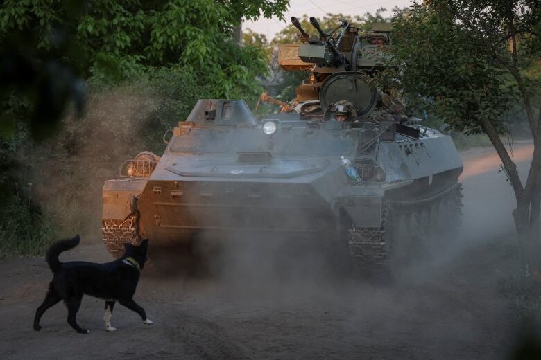 A member of a Ukrainian air defence unit is seen riding in an armoured personnel carrier near Bakhmut, Ukraine, on Thursday, May 23, 2024.