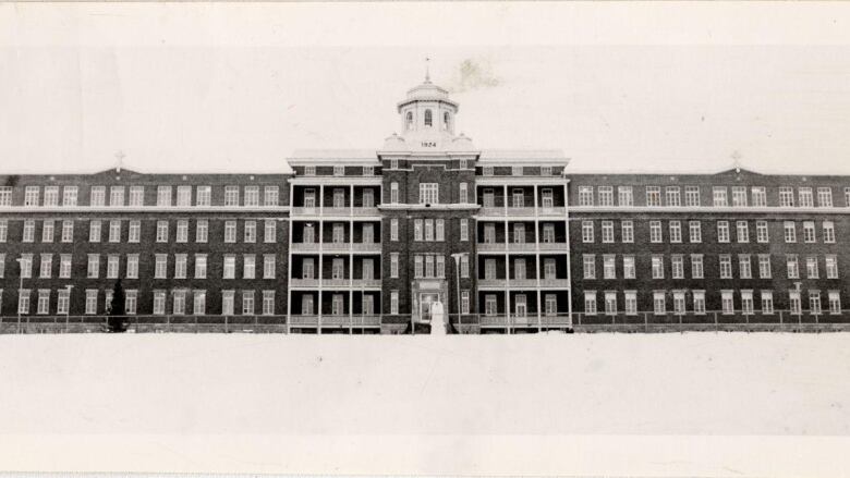 A black and wite image of a brick building 