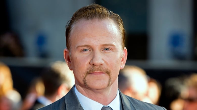 A man in a suit poses for a close-up.