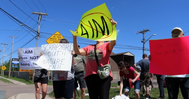 People holding signs saying 