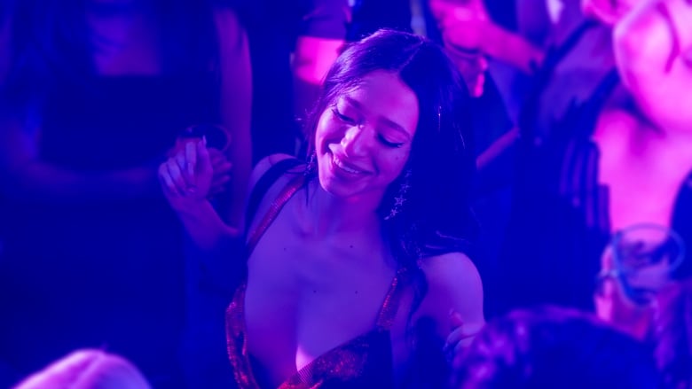 A person dances in a club.