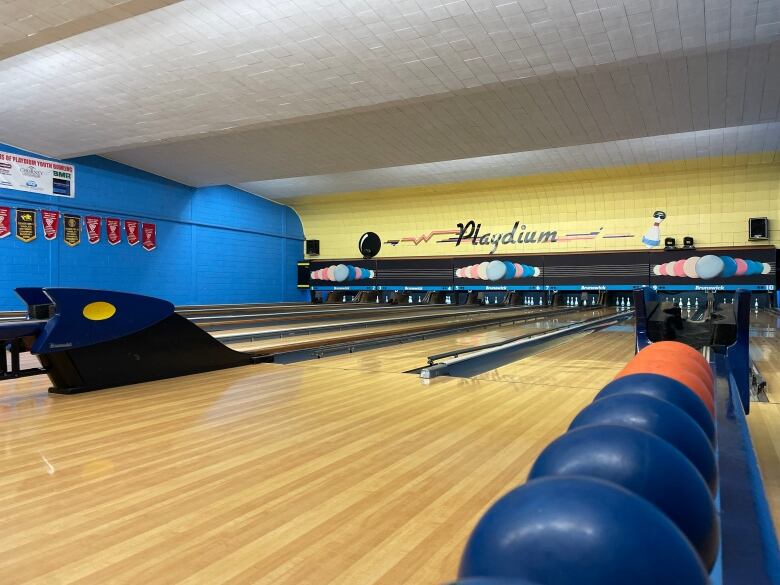 Bowling balls and lanes are shown.