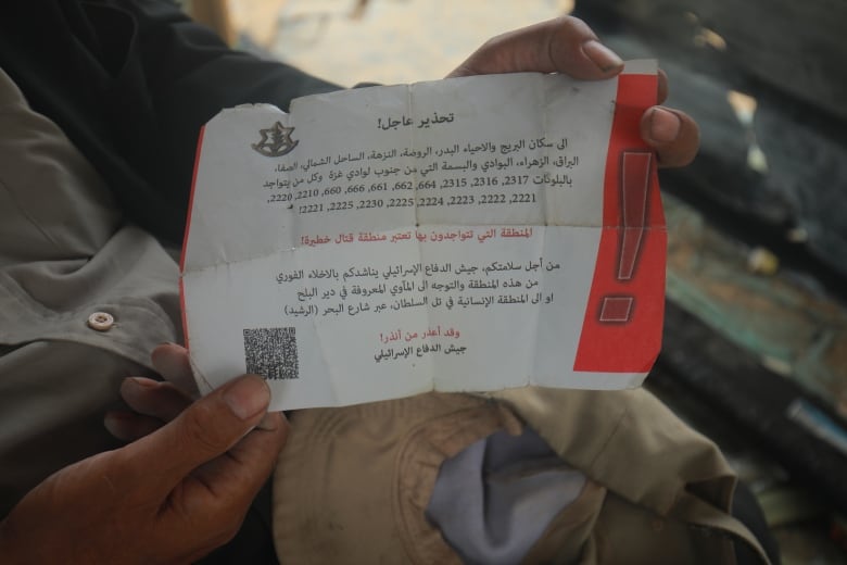 A red and white leaflet with Arabic writing is pictured.