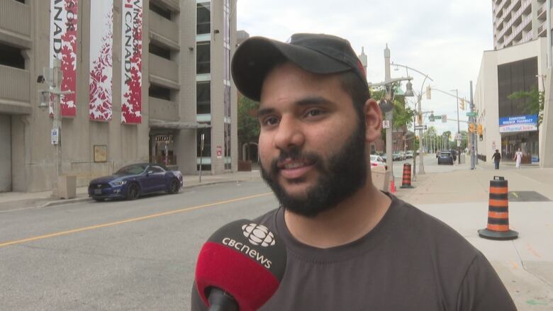 A man speaks into a CBC microphone