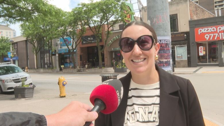 A woman speaks into a CBC microphone