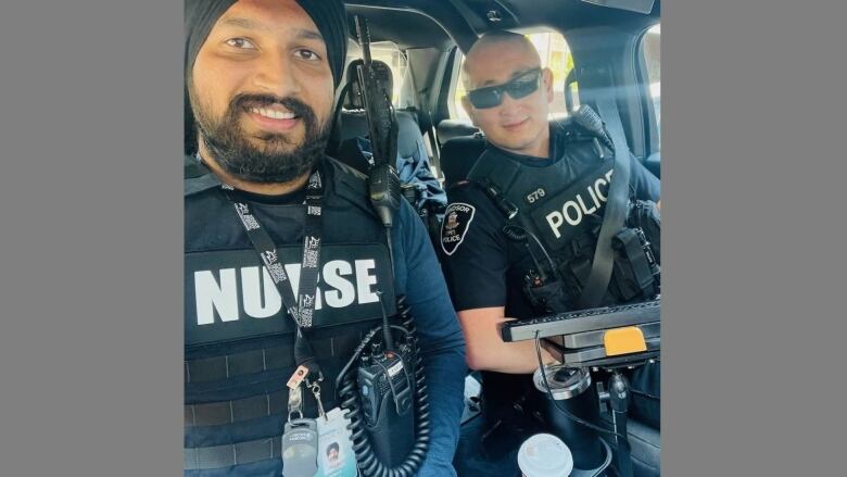 A nurse and a police officer in a patrol vehicle.