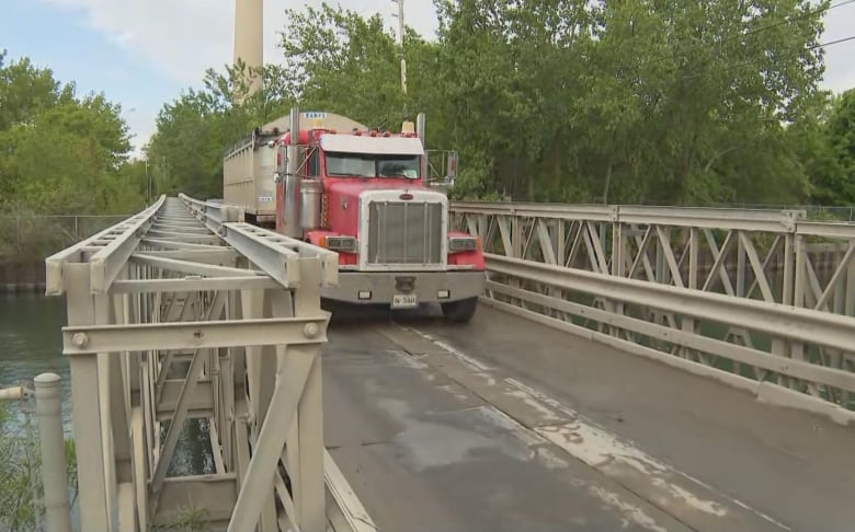 A dump truck crosses the single-lane Unwin Avenue bridge in the Port Lands.