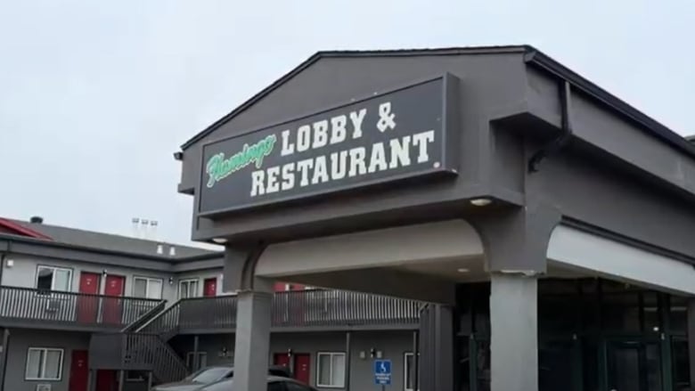 A hotel and restaurant is shown on a grey day.