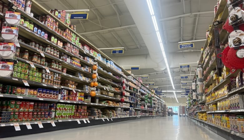 Looking down a shiny grocery story aisle