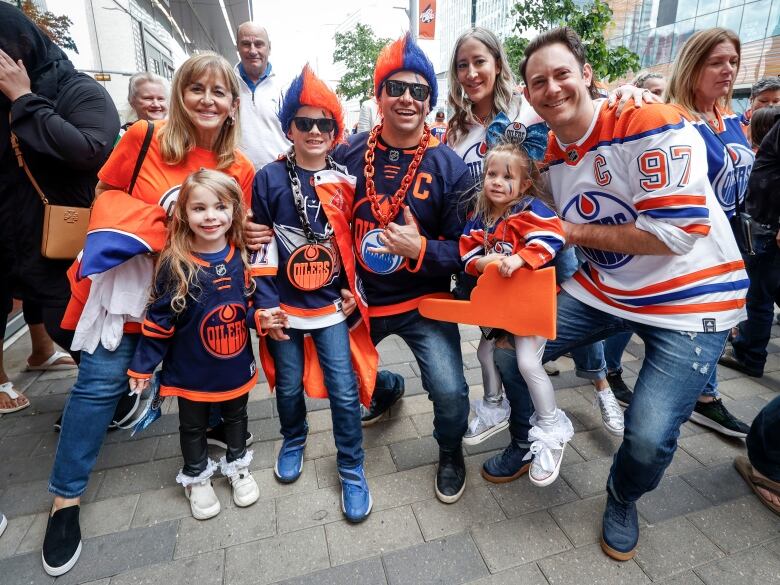 Hockey fans stand outside a stadium.